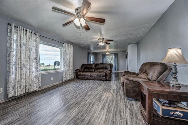 living room with a textured ceiling, hardwood / wood-style flooring, and a wealth of natural light