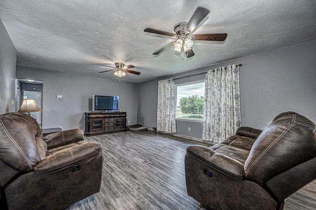 living room featuring a textured ceiling, hardwood / wood-style flooring, and ceiling fan