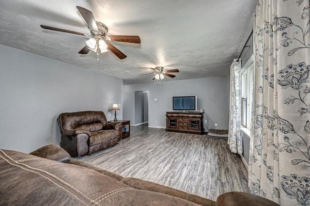 living room featuring wood-type flooring and a textured ceiling