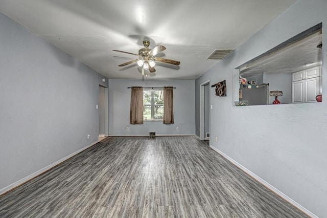 empty room featuring ceiling fan and dark wood-type flooring