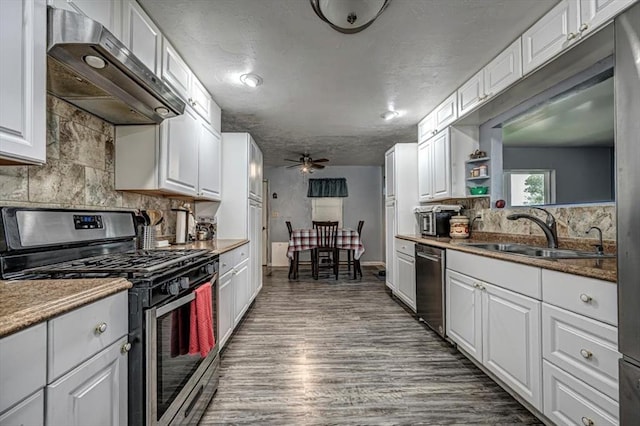 kitchen featuring ventilation hood, stainless steel appliances, sink, dark hardwood / wood-style floors, and white cabinetry