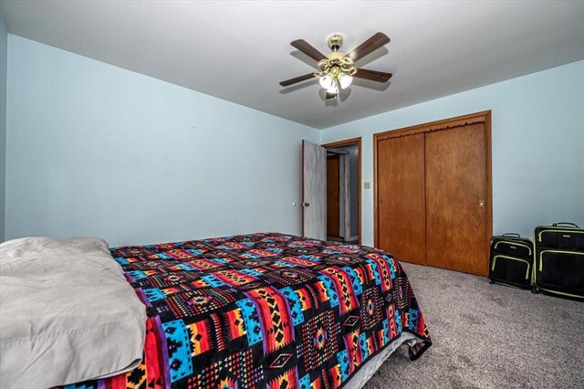 bedroom with carpet floors, a closet, and ceiling fan