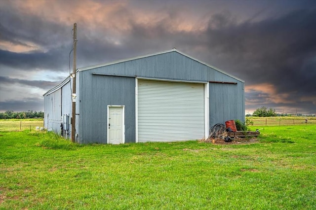 view of outbuilding featuring a garage and a yard