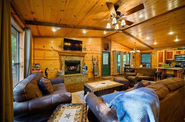 living room with vaulted ceiling with beams, wood walls, a fireplace, and wood ceiling