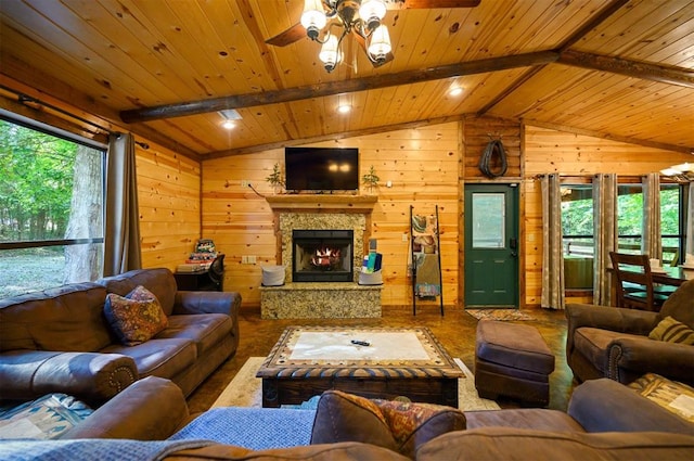 living room featuring wood walls, lofted ceiling with beams, and ceiling fan