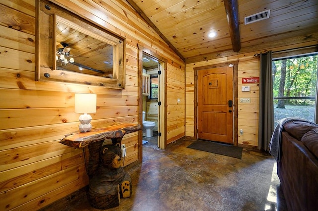 foyer featuring ceiling fan, wood walls, lofted ceiling, and wooden ceiling