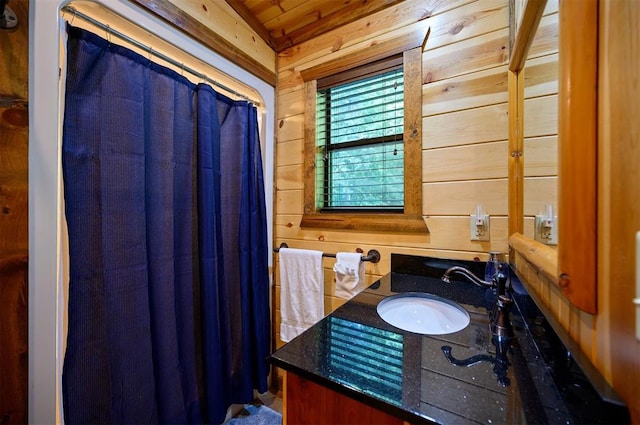 bathroom with wood walls and vanity