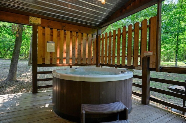 wooden deck featuring a hot tub