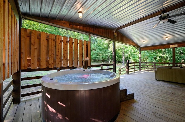 deck with a hot tub and ceiling fan