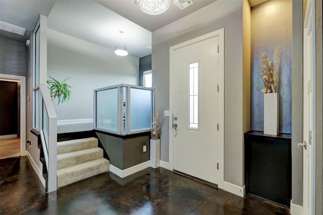 foyer with a chandelier