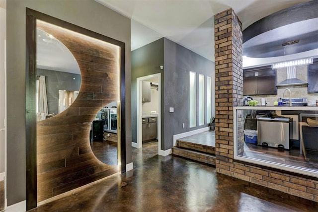 interior space with concrete flooring, sink, and a healthy amount of sunlight