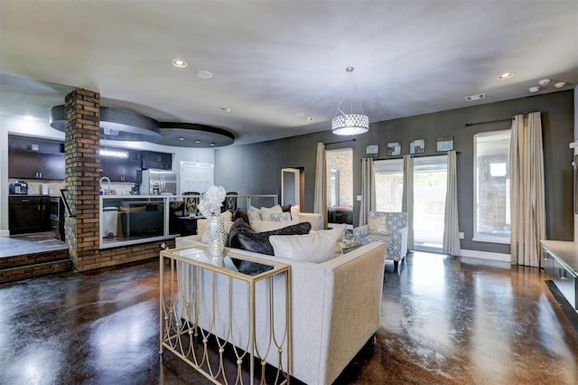 living room featuring decorative columns