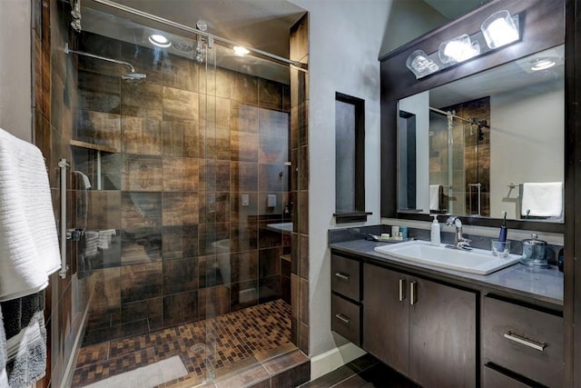 bathroom featuring vanity, tile patterned floors, and walk in shower