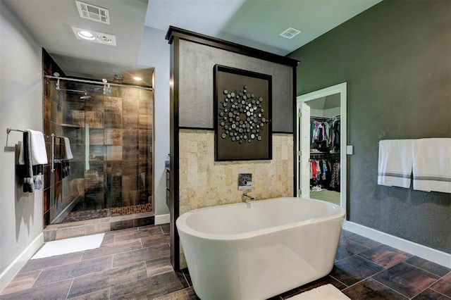 bathroom featuring shower with separate bathtub