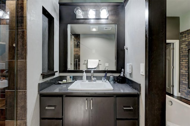 bathroom with vanity and a tile shower