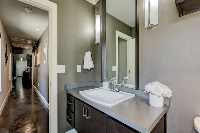 bathroom with vanity and concrete floors