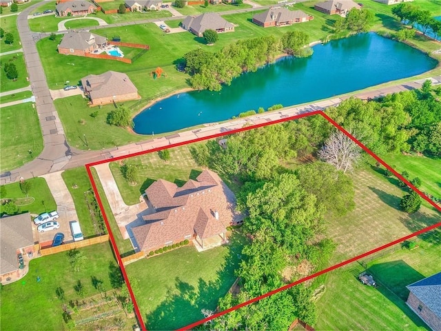 birds eye view of property with a water view