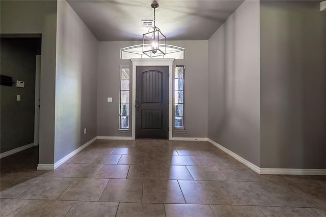 entryway featuring light tile patterned floors and a notable chandelier