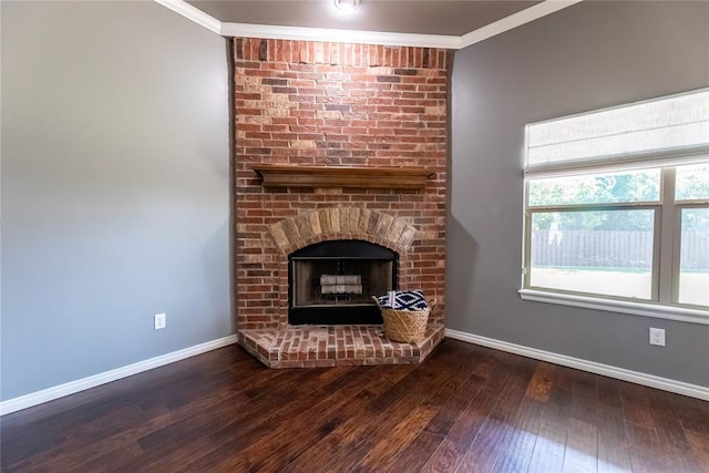 unfurnished living room featuring ornamental molding, a brick fireplace, and dark hardwood / wood-style floors