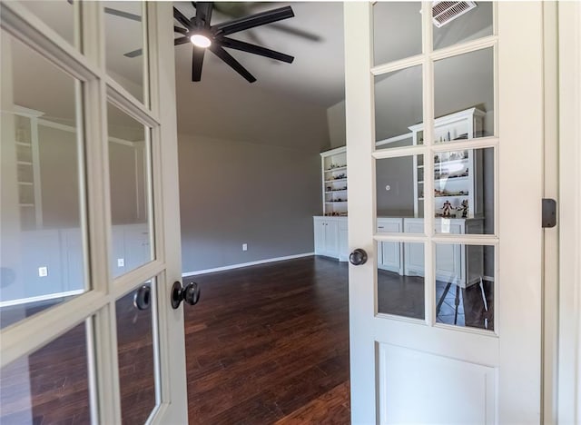 spare room featuring vaulted ceiling, dark hardwood / wood-style floors, ceiling fan, and french doors