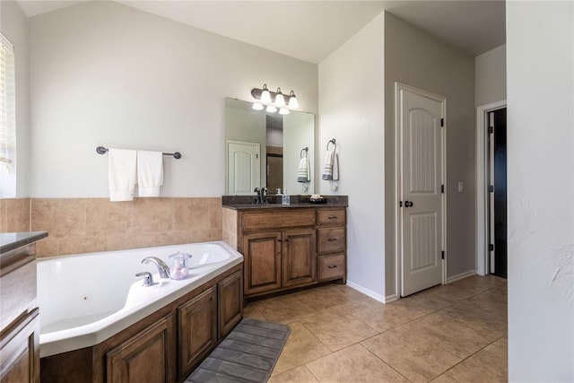 bathroom with tile patterned floors, vanity, and a bath