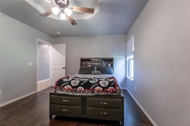 bedroom with dark hardwood / wood-style floors and ceiling fan