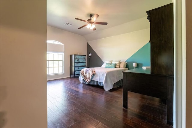 bedroom with vaulted ceiling, dark wood-type flooring, and ceiling fan