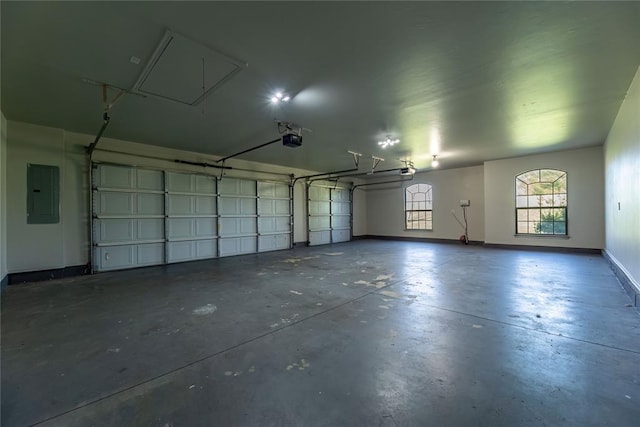 garage with a garage door opener and electric panel