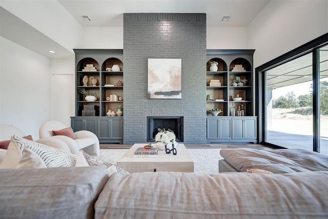 living room featuring a fireplace and light wood-type flooring