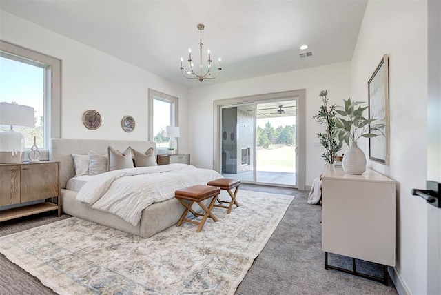 bedroom with dark colored carpet, access to exterior, and an inviting chandelier