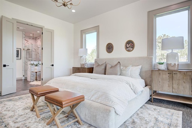 bedroom with a chandelier and multiple windows