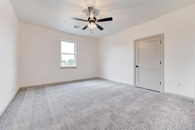 empty room featuring ceiling fan and carpet floors