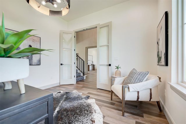 sitting room featuring french doors and light hardwood / wood-style floors