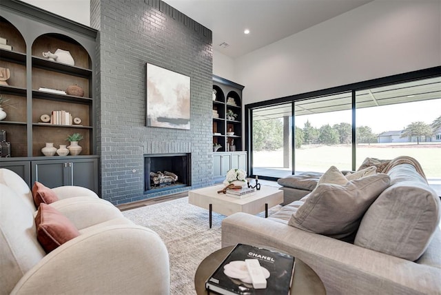 living room featuring a fireplace and built in features