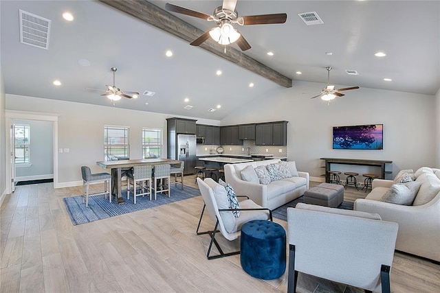 living room featuring ceiling fan, beam ceiling, light hardwood / wood-style floors, and high vaulted ceiling