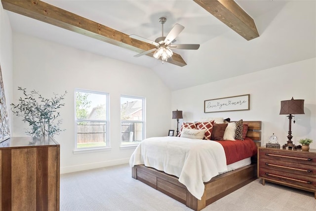 carpeted bedroom with vaulted ceiling with beams and ceiling fan