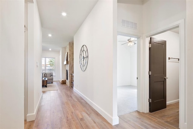 corridor with light hardwood / wood-style floors