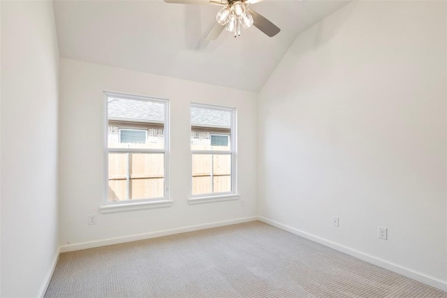 carpeted empty room featuring ceiling fan and lofted ceiling