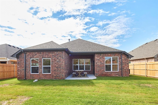 back of property featuring a patio and a lawn