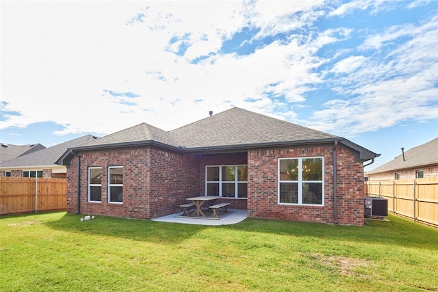 rear view of house featuring a patio area, a yard, and central air condition unit