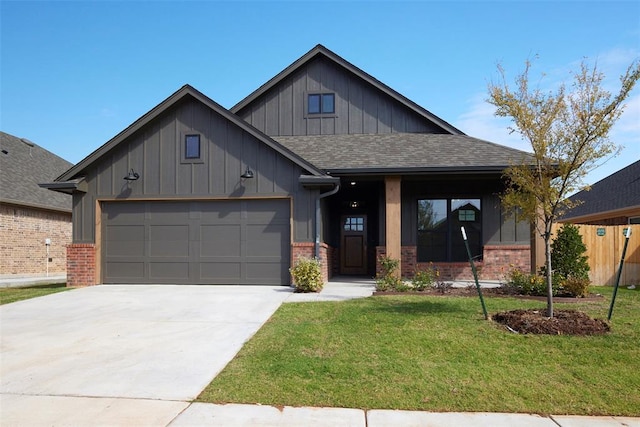 view of front of home featuring a front yard and a garage