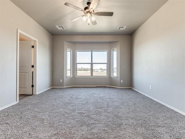 carpeted empty room featuring ceiling fan