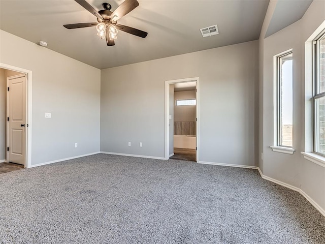 carpeted spare room featuring ceiling fan