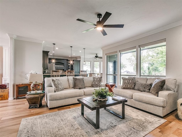 living room with ceiling fan, light hardwood / wood-style floors, and ornamental molding