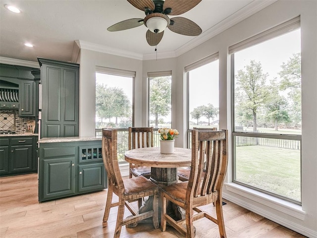 sunroom / solarium featuring a wealth of natural light and ceiling fan