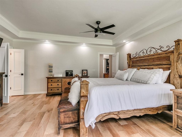 bedroom featuring ceiling fan, light wood-type flooring, and crown molding