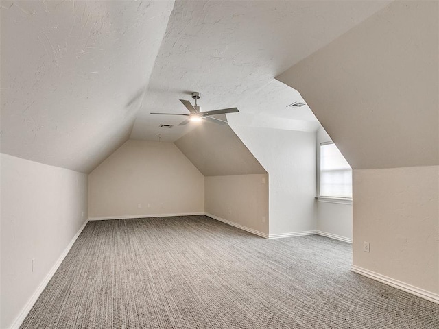 bonus room featuring ceiling fan, lofted ceiling, and carpet floors