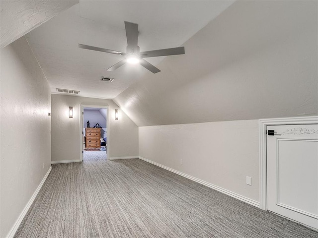 additional living space with carpet flooring, vaulted ceiling, and ceiling fan