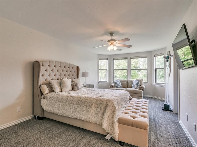 bedroom featuring ceiling fan and dark colored carpet