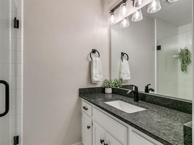 bathroom with a shower with door and vanity